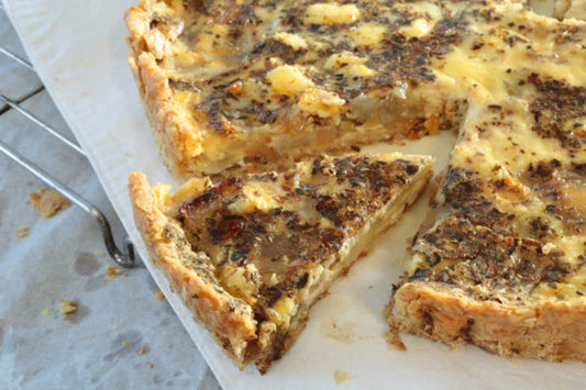 Flavorful caramelized onion and feta quiche, a delightful blend of savory fillings in a golden crust.
